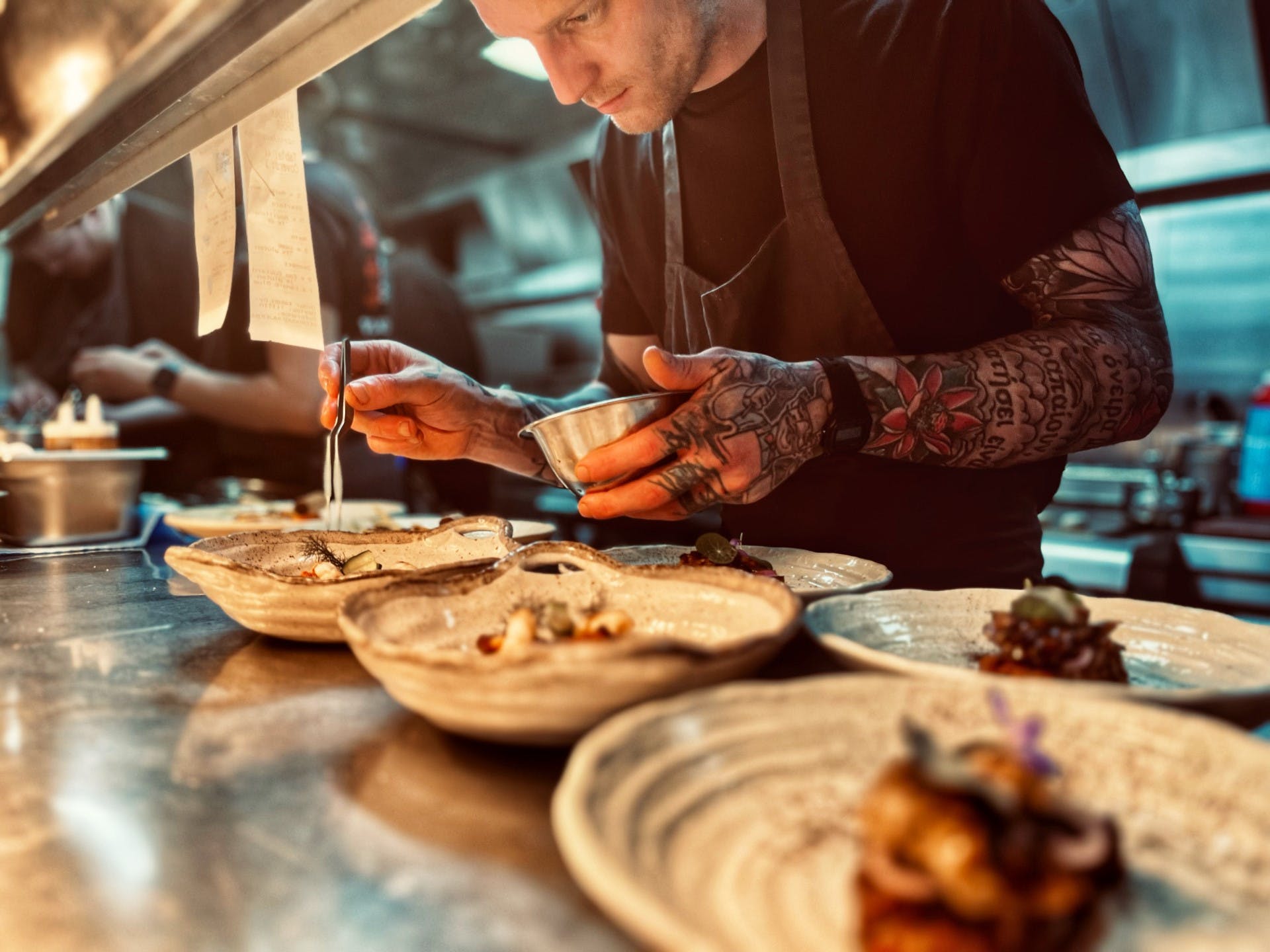 A chef puts the finishing touches to a tasty meal.