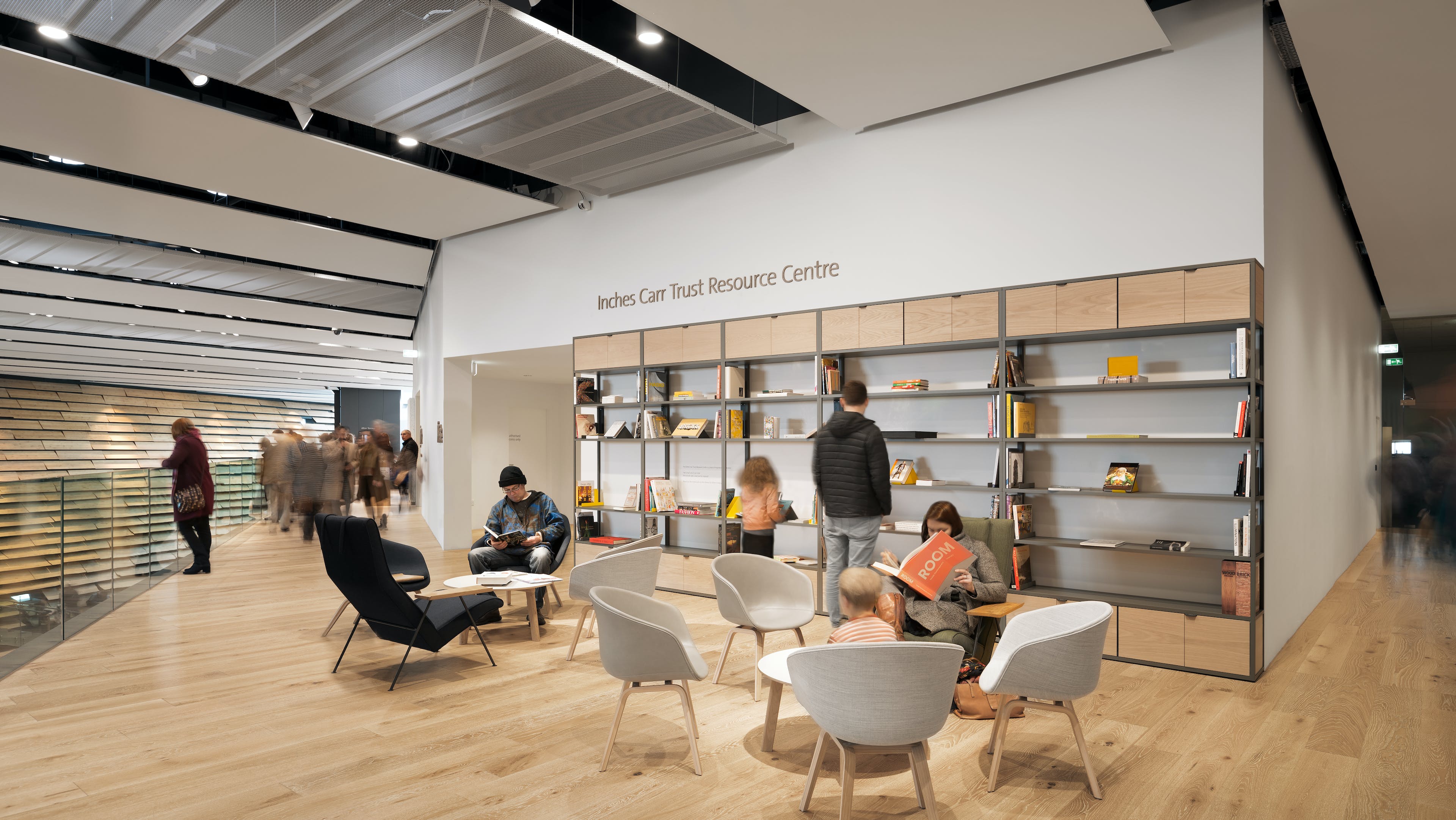 People sitting reading books in the Inches Carr Resource Centre within V&A Dundee